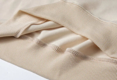 Close-up of beige fabric with a white background