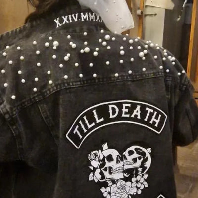 Black denim jacket with white pearl embellishments and 'Till Death' design on a mannequin.