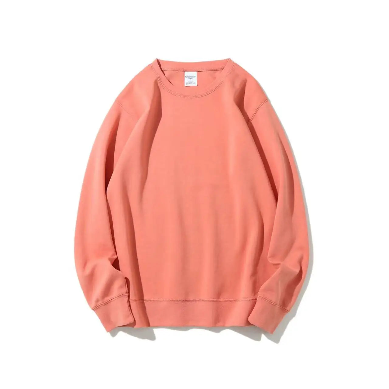 Peach-colored sweatshirt on a white background