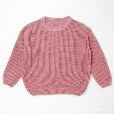Pink knitted sweater on a white background